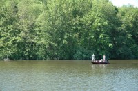 family fishing on lake